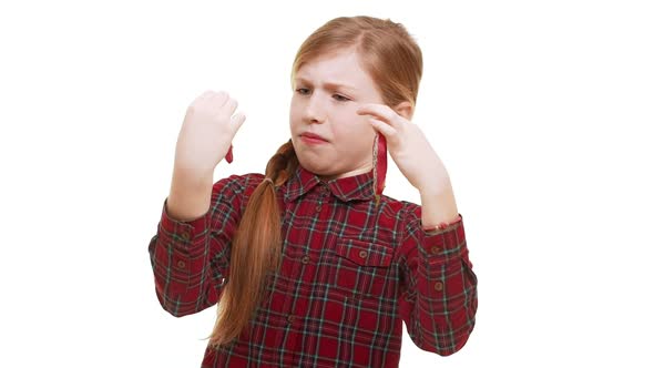 Caucasian Elementaryschool Aged Girl Cautiously Holding Two Pieces of Pitaya and Covering Eyes with