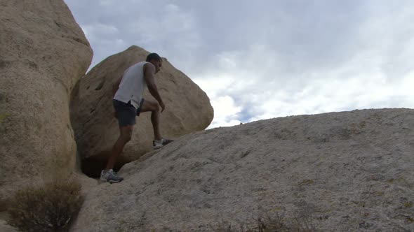 Male climbing rocks