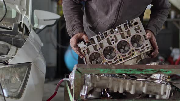 Car Master Repairing Cylinder Head Of Car Engine In Repair Shop 2