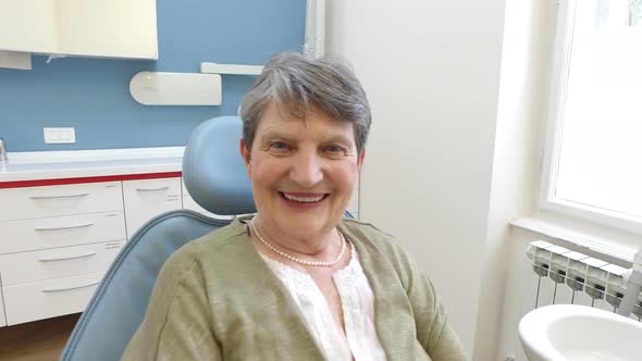 Close up of happy elderly female patient at dentist