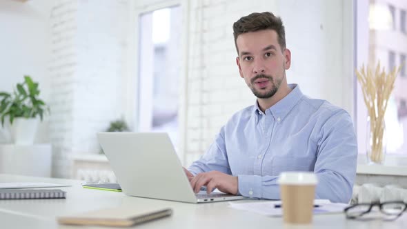 Creative Man Saying No with Finger Sign at Work