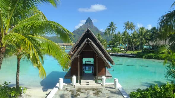 Aerial drone view of a luxury resort and overwater bungalows in Bora Bora tropical island