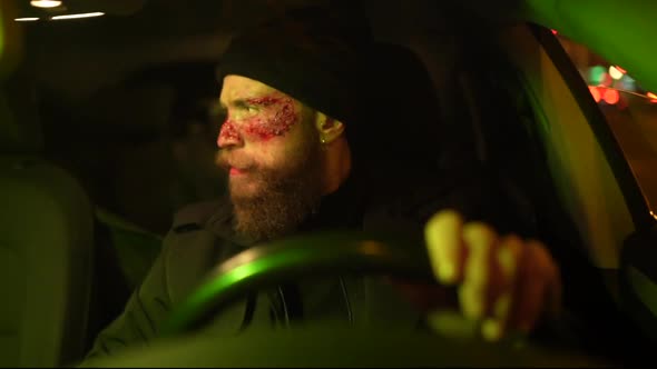 Hipster man with beard and cinema makeup driving a car