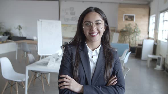 Cheerful Young Businesswoman Smiling at Camera