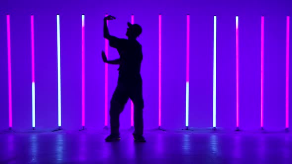 Silhouette of a Stylish Young Man Dancing and Performing Contemporary Choreography