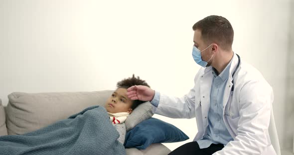 Pediatrician at Home Visiting Helping Little Black Girl