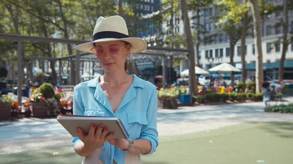 Young tourist with a travel book in the park