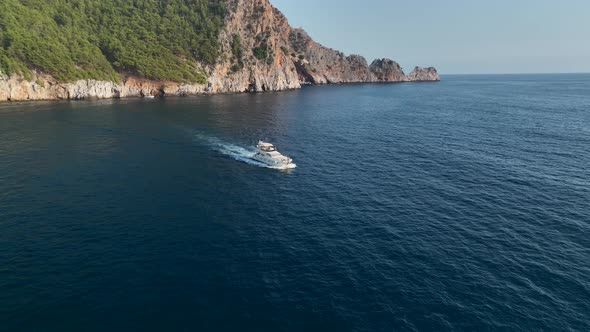 Luxury yacht sails to the port aerial view 4 K Turkey Alanya