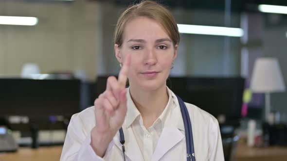 Portrait of Attractive Young Female Doctor Saying No By Finger