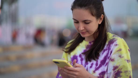 Closeup Cheerful Girl Walking with Smartphone in Urban Background