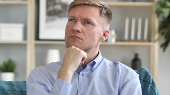 Portrait of Thinking Middle Aged Businessman in Office