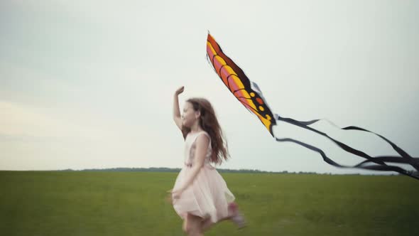 Girl Running Around with a Kite on the Field. Freedom Concept.