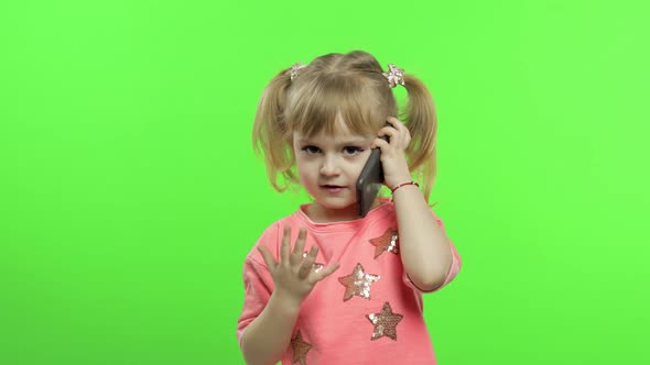 Little Girl Using Smartphone. Child Emotionally Talking on on Mobile Phone