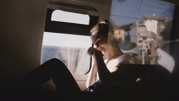 Beautiful Happy Caucasian Girl Smiling, Talking on Phone and Hanging Up While Traveling