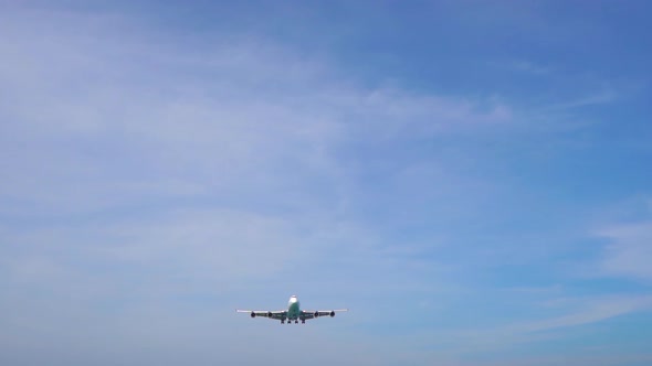 Superslowmotion Shot of a Tropical Beach Where Airplanes Fly Over Tourists Heads Before Land in an