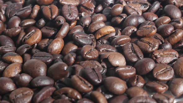 Pile of roasted coffee beans  4K tilting video