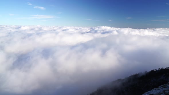 Aerial View of Thick Fog Like Beautiful Ocean of Clouds and Mountain Peaks Above Clouds