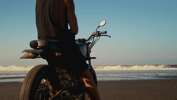 Watching Waves on Ocean Beach Motorcyclist is on Shore