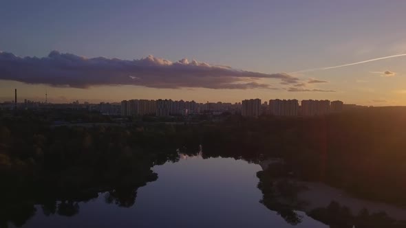 Flight Over the Lake During Sunset Overlooking the City with Beautiful Clouds, Ukraine Kiev