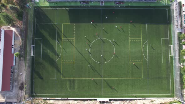 Football Players Training on the Green Soccer Field