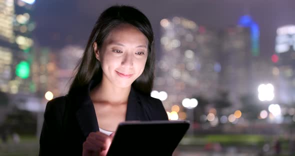 Young businesswoman use of tablet computer at night