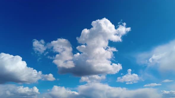 White clouds fly across a bright blue sky, Cloud time lapse