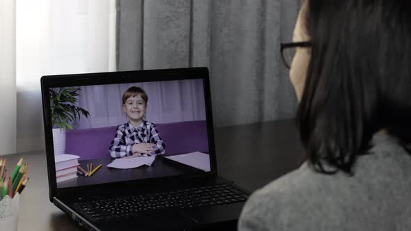 Woman Teacher Making Video Call on Laptop with Little Pupil. Distance Education