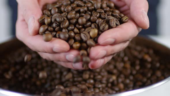 Man Taking Handful of Coffee Beans