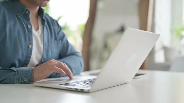 Close Up of Male Hand Working on Laptop