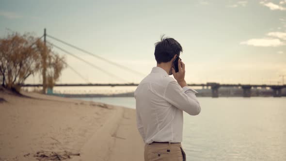 Walking And Using Mobile Phone. Businessman Chatting On Mobile Phone With Friend  Sending Massage.