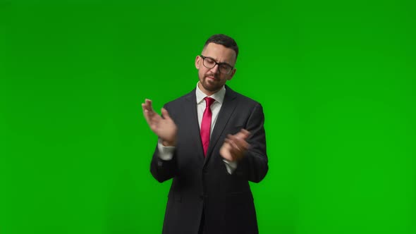 Happy Young Businessman Standing and Applauding on a Green Screen