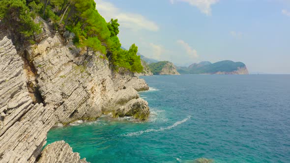 Aerial View of Sea Turquoise Waves and Fantastic Rocky Coast with Pine Trees Montenegro