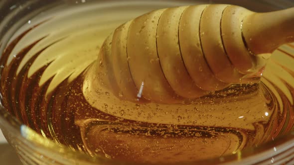 Honey dripping, pouring from honey dipper