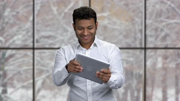 Cheerful Businessman Playing Game on Digital Tablet