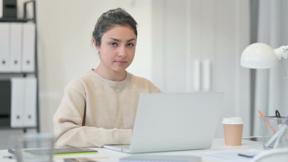 Indian Woman with Laptop Shaking Head in Denial 