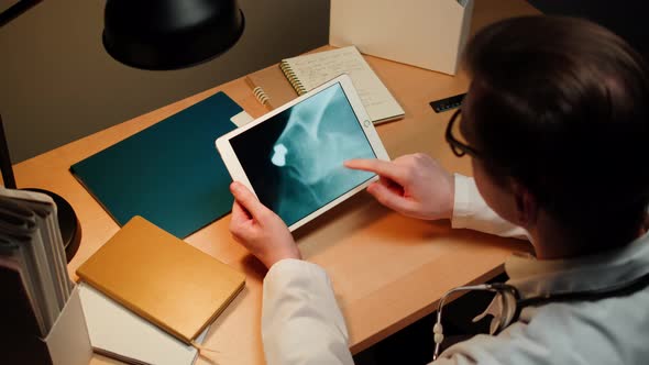 Doctor Veterinarian Examining Cat or Dog Skeleton Roentgen on Gadget Tablet