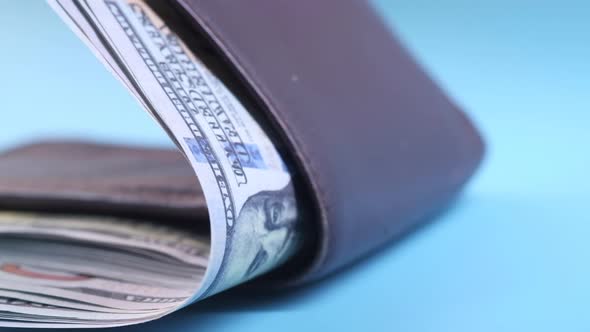 Close Up of Cash in Wallet on Table.