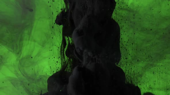 Cloud of black paint mixing into water over green screen