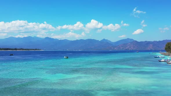 Aerial flying over panorama of perfect seashore beach journey by shallow ocean with white sandy back