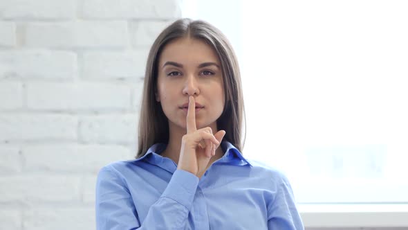 Woman Gesturing  Silence, Finger on Lips