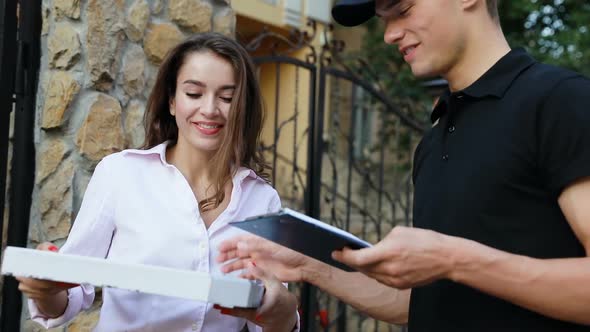 Courier Delivering Pizza. Woman Receiving Food Package Near Home