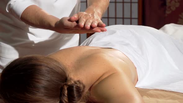 Professional Masseur Applying Oil To the Back of His Client, Preparing To Massage