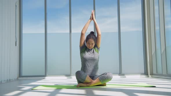 Exercise concept. Portrait of gorgeous young woman practicing yoga indoor, 4k Resolution