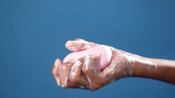 Young Man Washing Hands with Soap Warm Water
