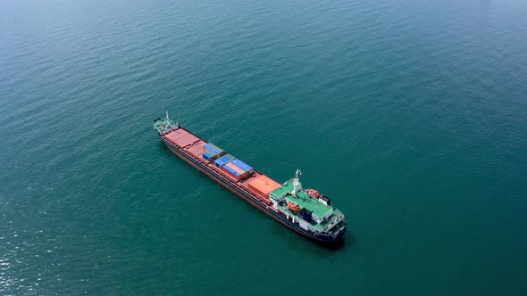 A drone flight over an empty container ship into the sea