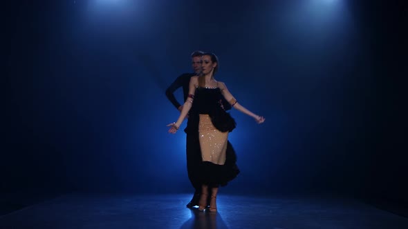 Jive Dancing Pair of Professional Elegant Dancers in Smoky Studio