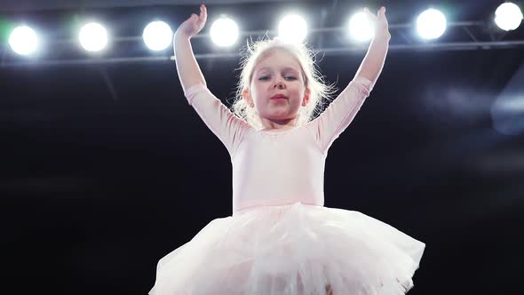 Child Ballerina in Pink Tutu Sends a Kiss and Waves To the Audience From the Stage