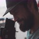Bearded man smiling and looking through a visor of a vintage camera - VideoHive Item for Sale