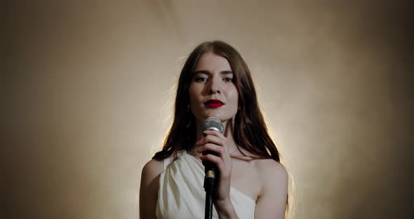 The Girl Singer Sings Into the Microphone and Completes the Song and Leaves, the Scene in Smoke