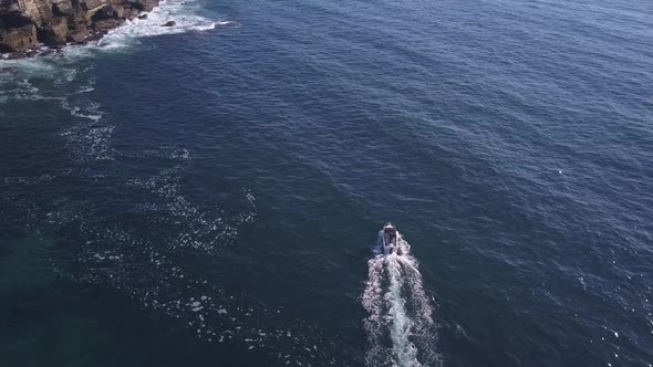 Top down overhead flyover a single speed fishing boat on the ocean at Sydney Coastal waters